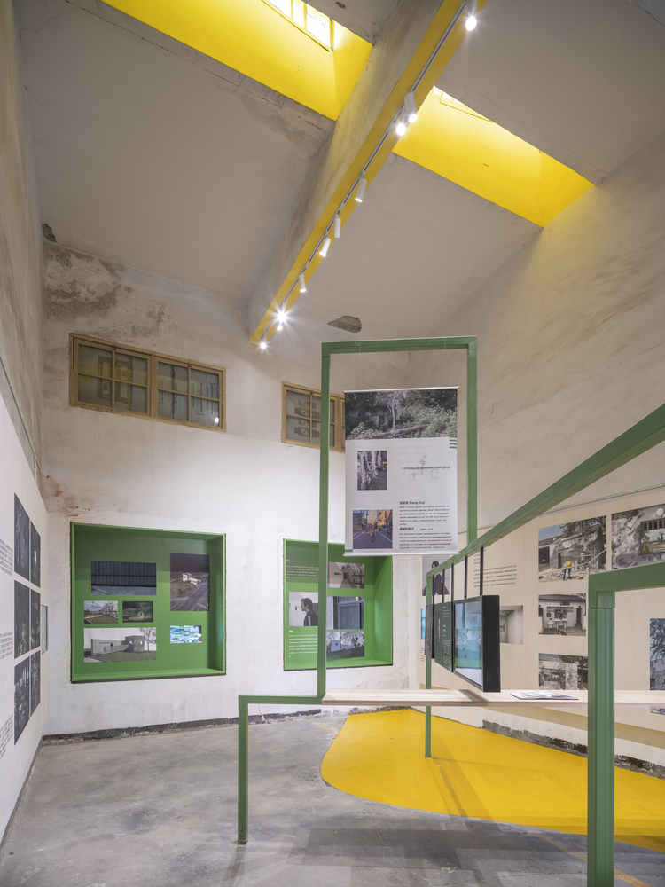 Green display frames and a yellow floor zone inside the South Gallery